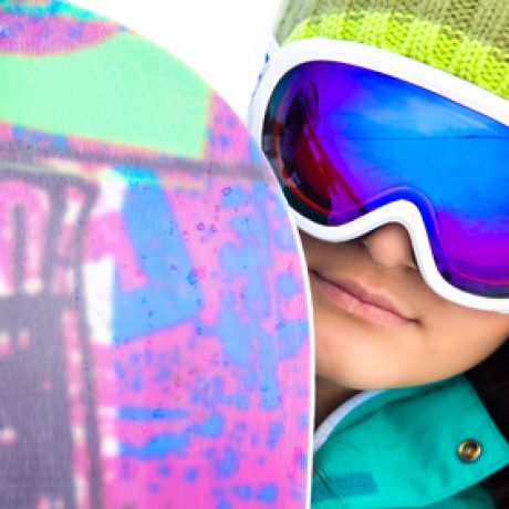young woman in sport sunglasses with a snowboard. close-up