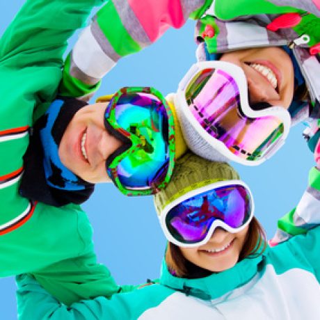 cheerful young friends in winter sportswear ski resort